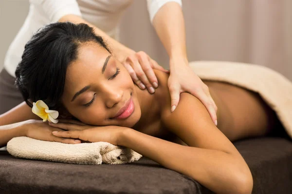 African woman receiving back massage