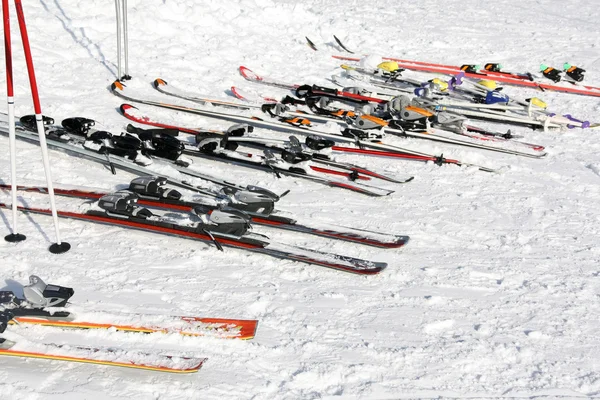 Parked skis in snow ground