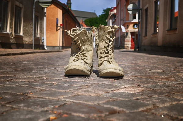 Muddy boots on street