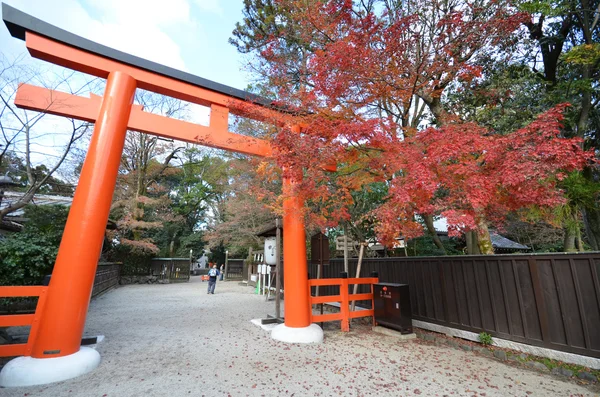 Tourists visit Shimogamo shrine orange archway in Kyoto, Japan