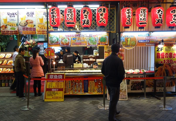 Customers queue to buy takoyaki in Osaka