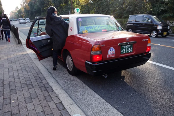 Passager get in a taxi in Kyoto