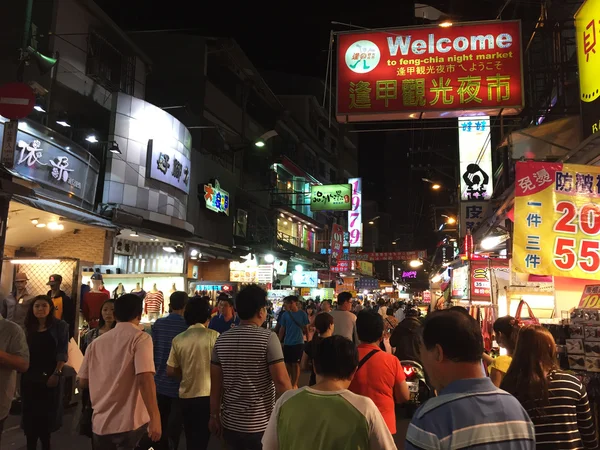 Pedestrians shopping at  Fengjia Night Market