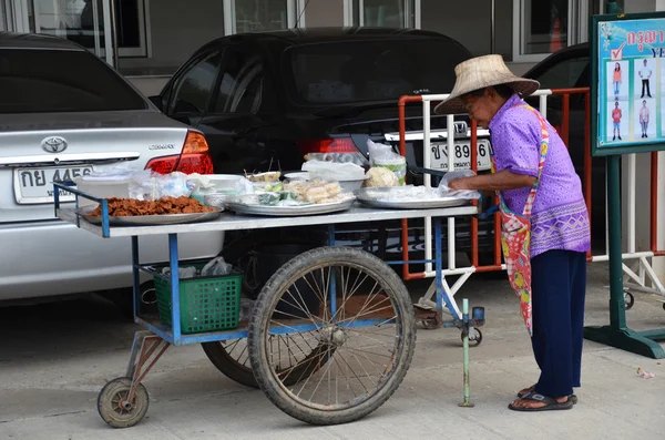 An street vendor prepares food at street