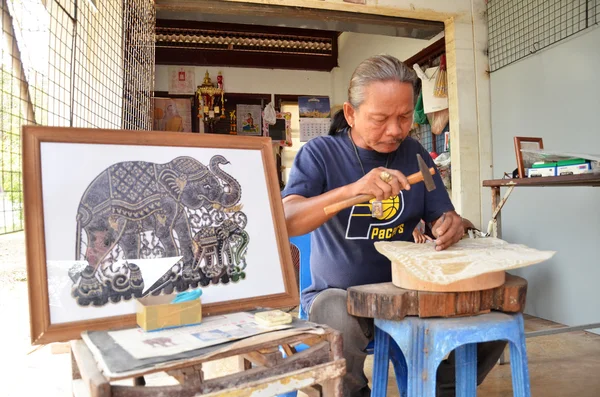 Artist creates the hand craft by using buffalo skin