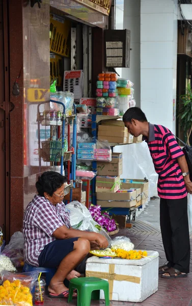 Street vendors wait for customers on the street