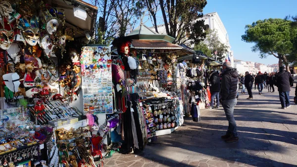 Vendors set up a stall on the street to sell colorful mask to tourist in Venice