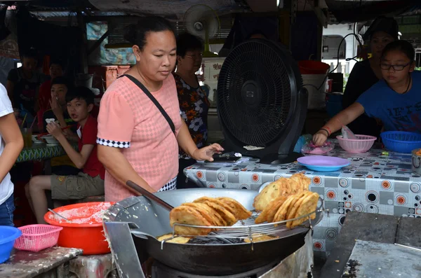Vendor sells food on the street in Kuala Sepetang, Malayisa