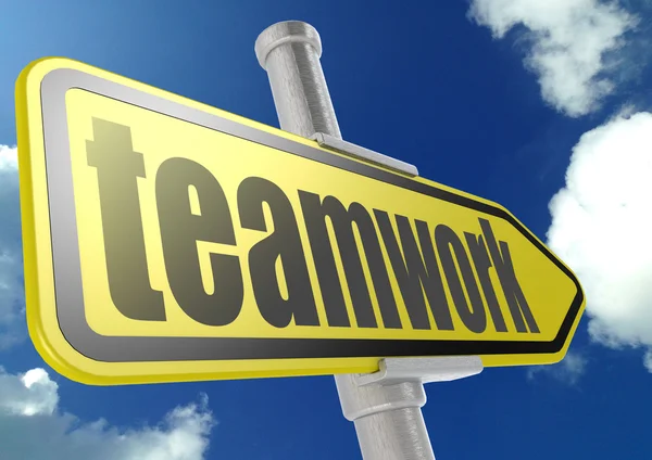Yellow road sign with teamwork word under blue sky