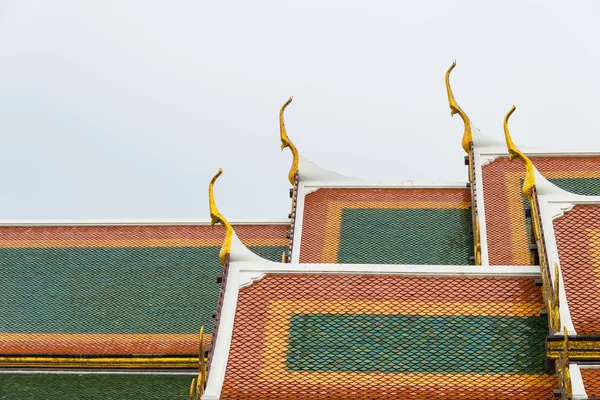 Ceramic roof tile temple in Thailand with cloudy sky