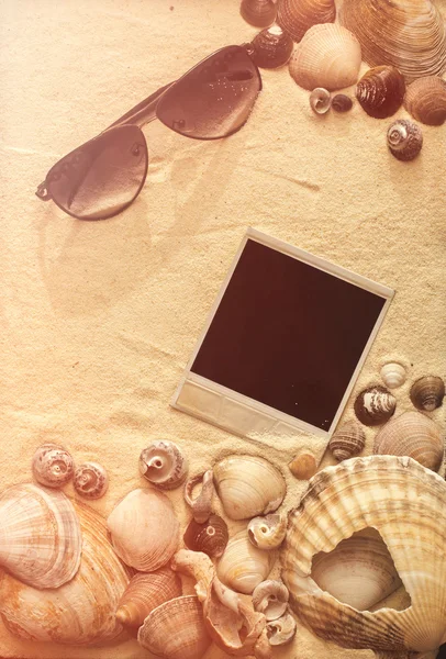 Sea shells, sunglasses and polaroid picture