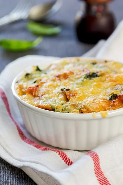 Baked pasta with spinach in tomato sauce