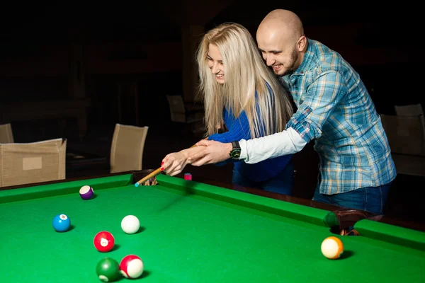 Picture of beauty couple in love plays pool billiard for the fir