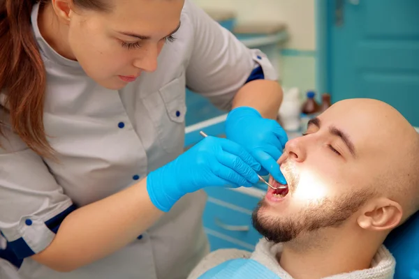 Horizontal photo of patient on the examination of the teeth at t