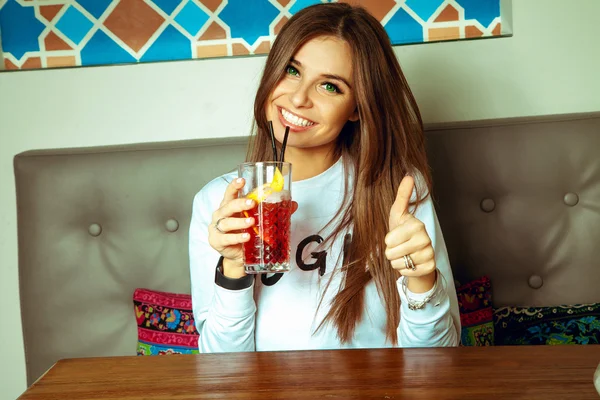 Happy young lady with green eyes smiling on camera