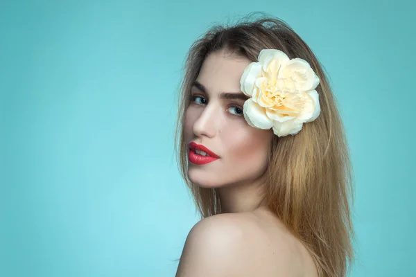 Portrait of pretty girl with flower in hair