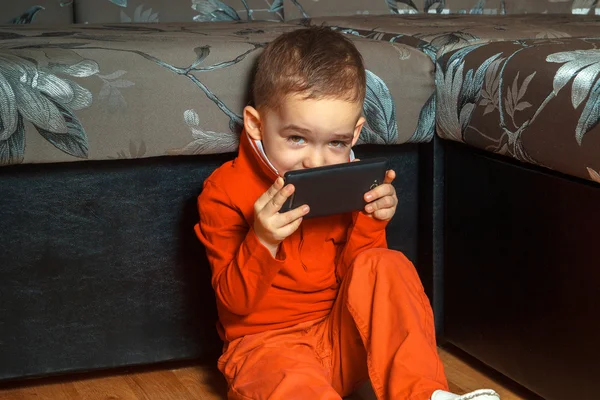 Young boy playing mobile games