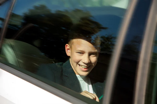 Boy smiling on the backseat