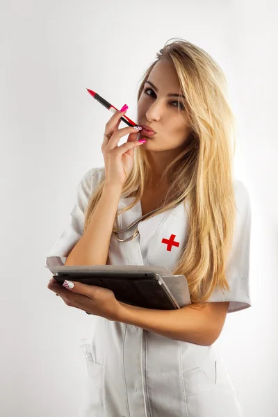 Nurse thinking and take pen in mouth