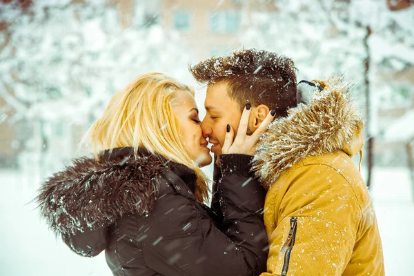 Horizontal photo of Man and woman happily kissing on the street