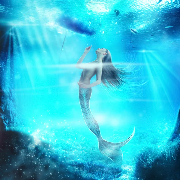 Adorable topless mermaid in the underwater world