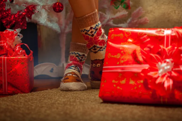 Horizontal photo of female legs in funny socks with a lot of chr