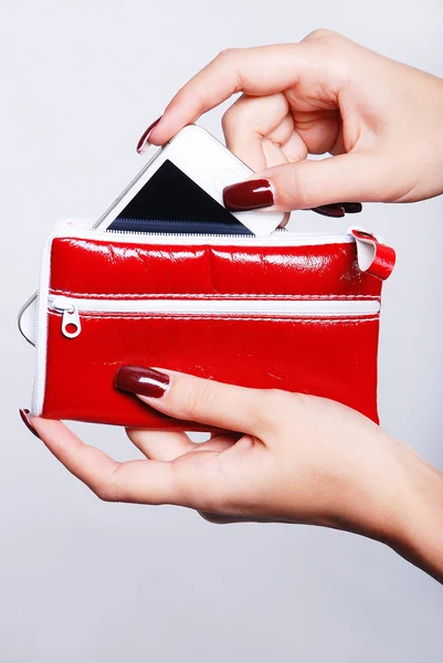 Female hands with red purse