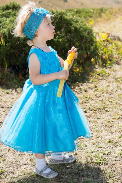 Little child girl with bubble blower