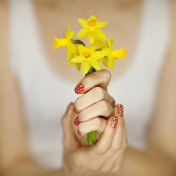 Woman hand with perfect nail art holding flower