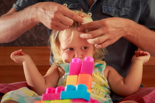 Girl plays toy constructor