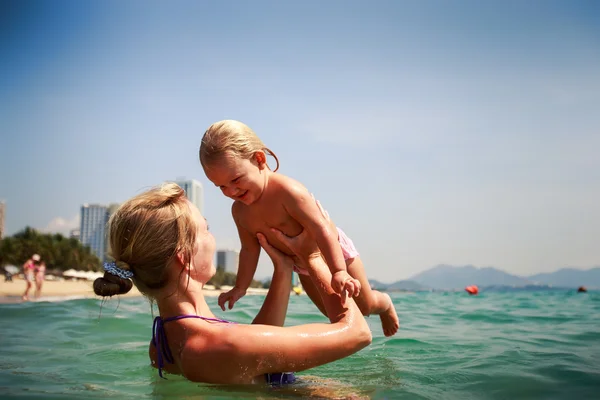 Mother in sea holds daughter