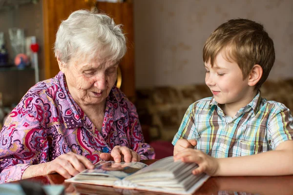 Grandmother and grandson looking photo album