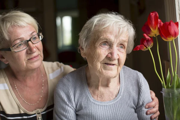 Woman hugging her old mother.