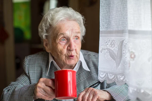 Elderly retired woman drinking tea