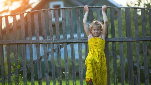 Little girl near fence