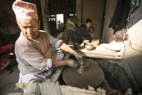 Nepalese man working in  pottery workshop