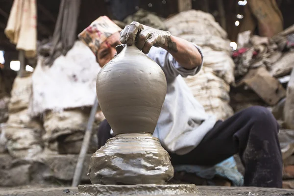 Man in pottery workshop