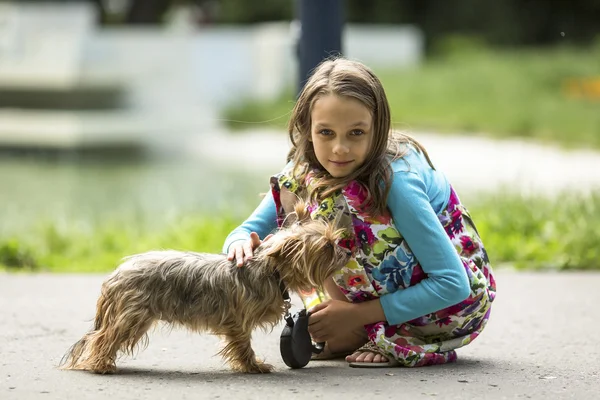 Sweet little girl with small dog.