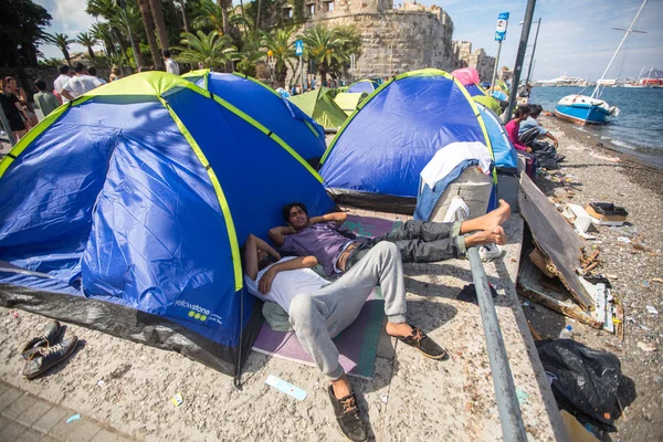 Unidentified war refugees near tents