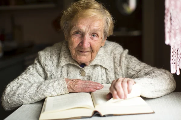 Old woman sitting with  book