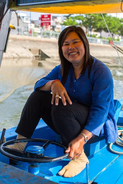 Woman drives a boat, Vietnam