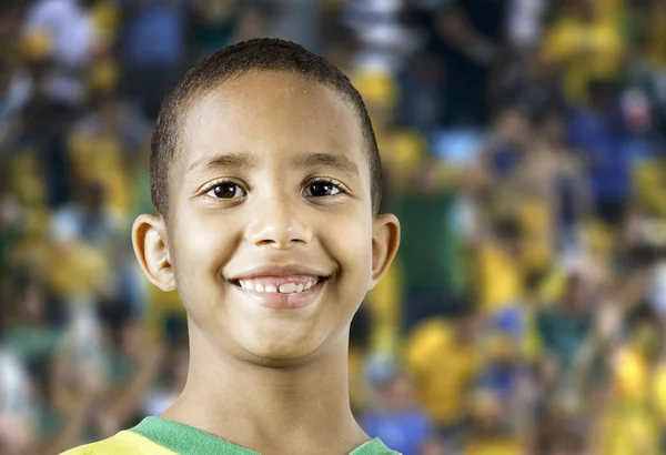 Little Brazilian boy smiling in the stadium