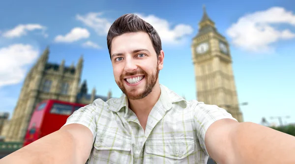 Happy young man taking a selfie photo in London, England