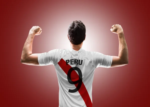 Peruvian soccer player on red background