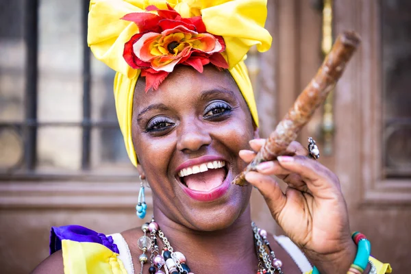 Portrait of african cuban woman smoking cigar and smiling