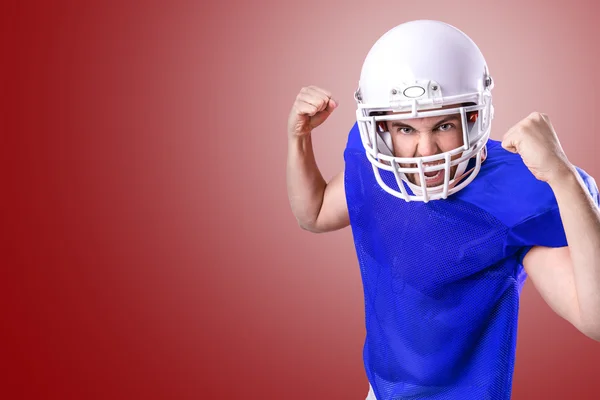 Football Player on blue uniform on red background
