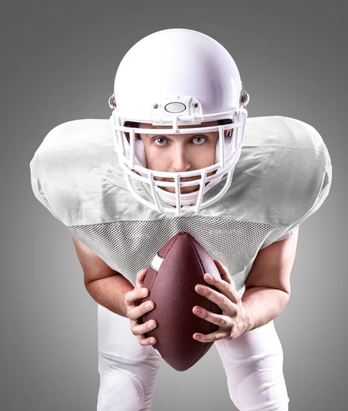 Football Player on white uniform on gray background