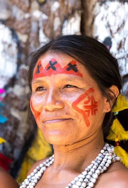 Native Brazilian woman smiling at an indigenous tribe in the Amazon