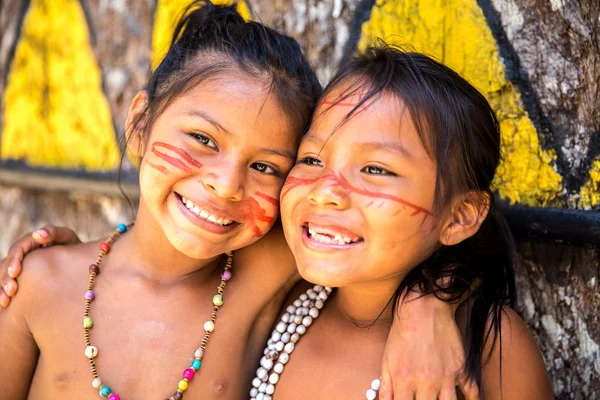 Native Brazilians girl smiling at an indigenous tribe in the Amazon