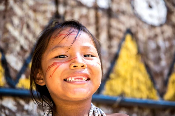 Native Brazilian girl smiling at an indigenous tribe in the Amazon